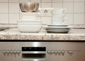 Dishes stacked on top of a dishwasher