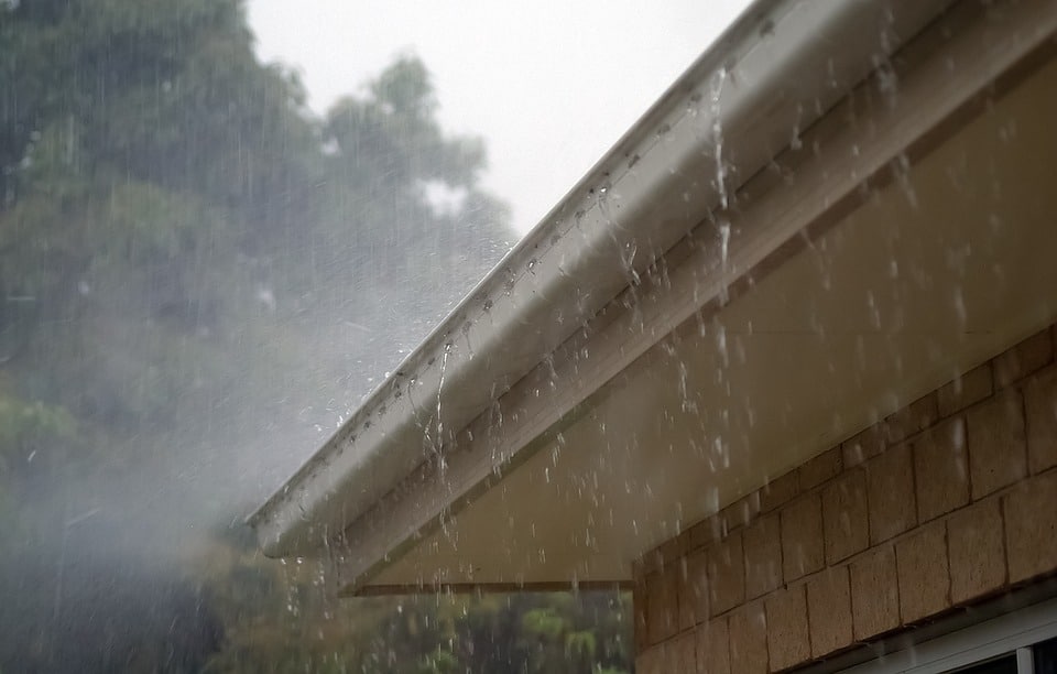 Surface water drainage. Rain falling on roof gutter.