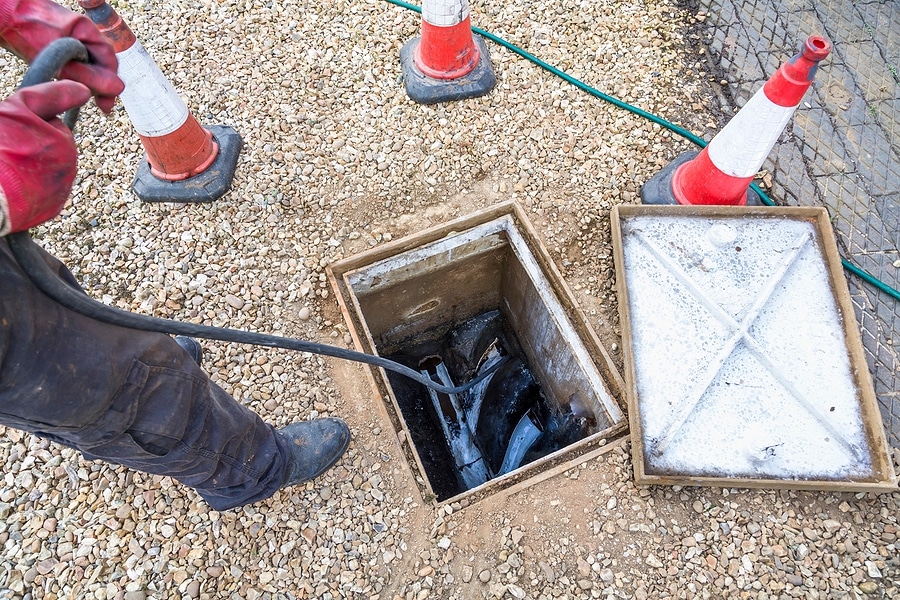 a tradesman unblocking a domestic drain