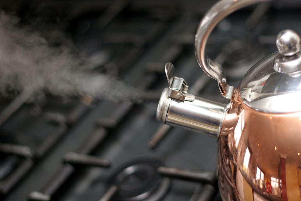 A copper kettle blowing steam