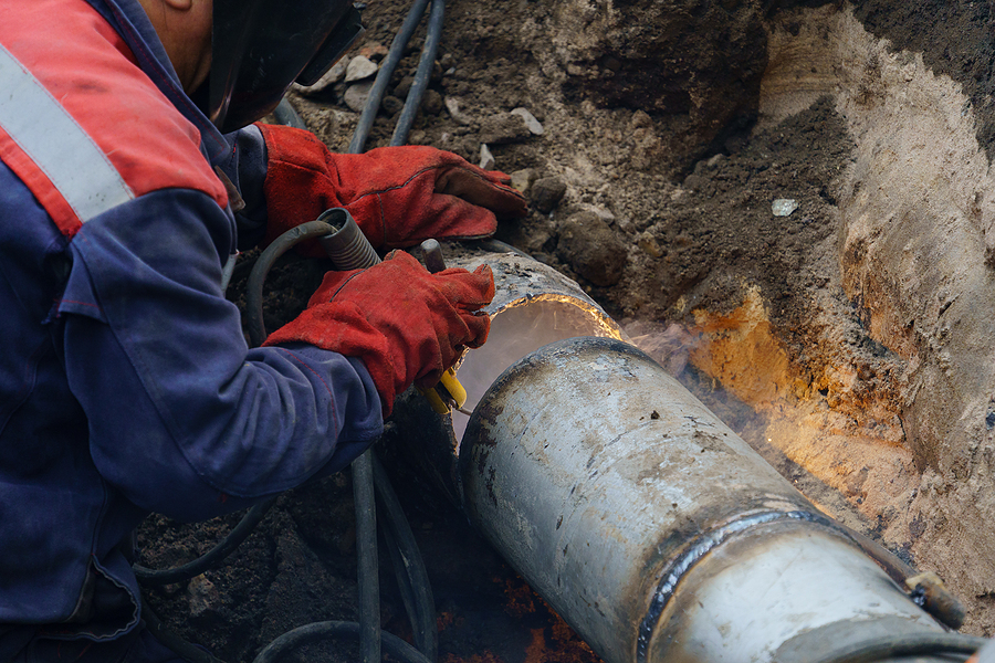 Worker fixing broken drain
